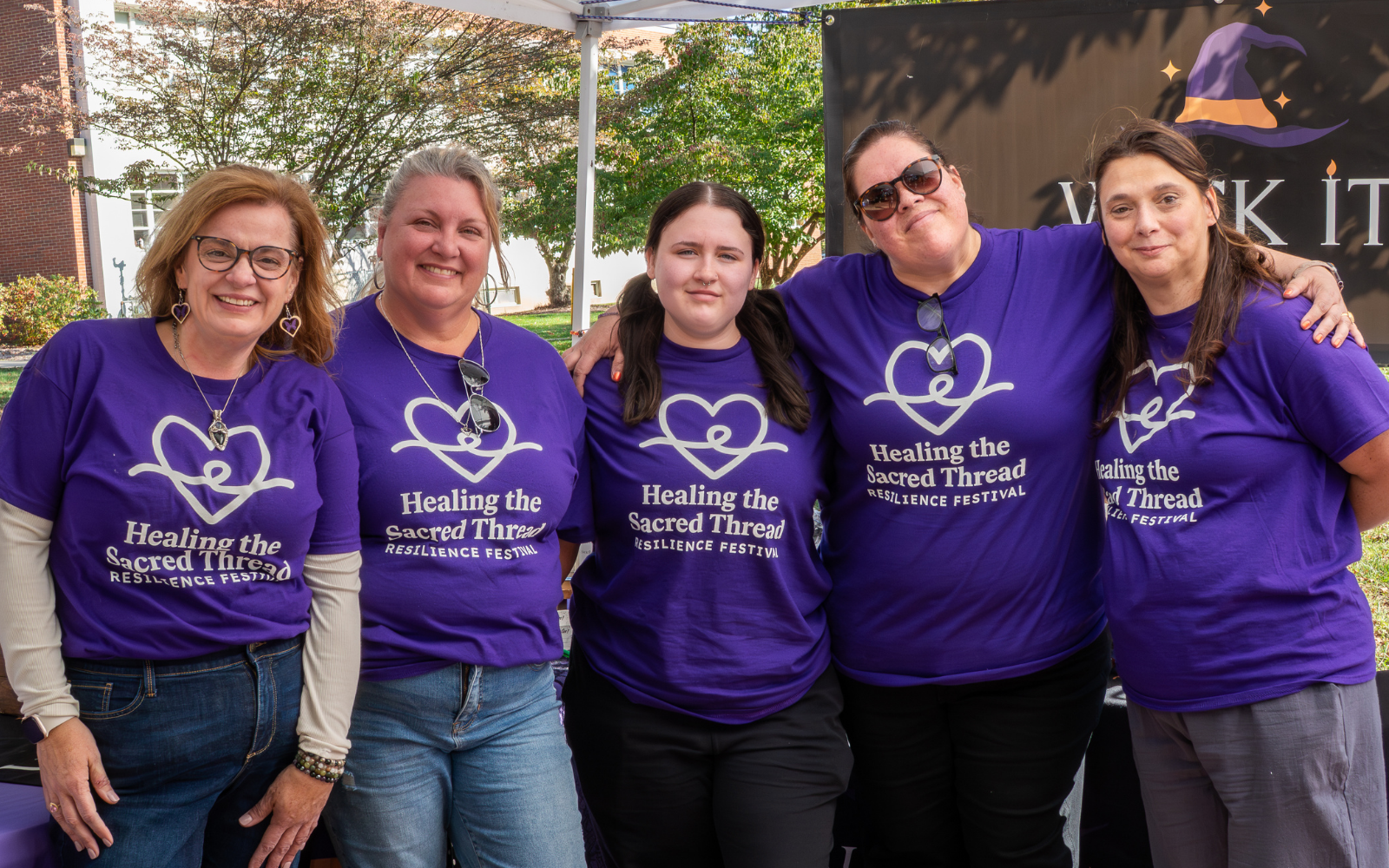 Healing the Sacred Thread Resilience Festival organizers wearing purple event shirts